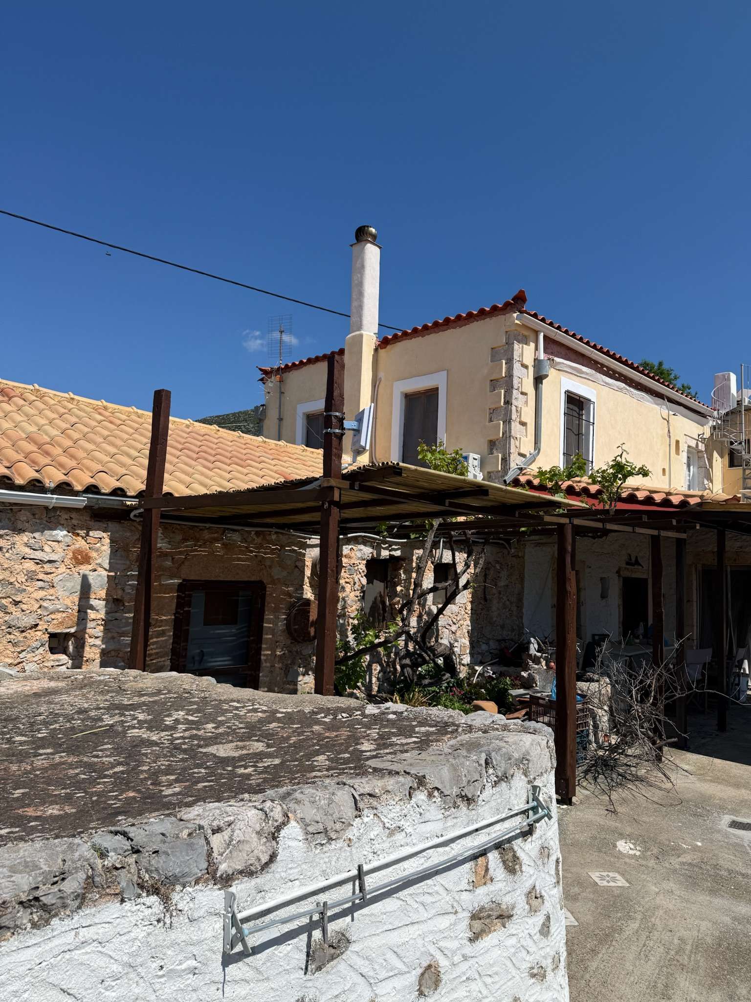 The stone house and vine-covered courtyard at Sparta Gaia Retreat