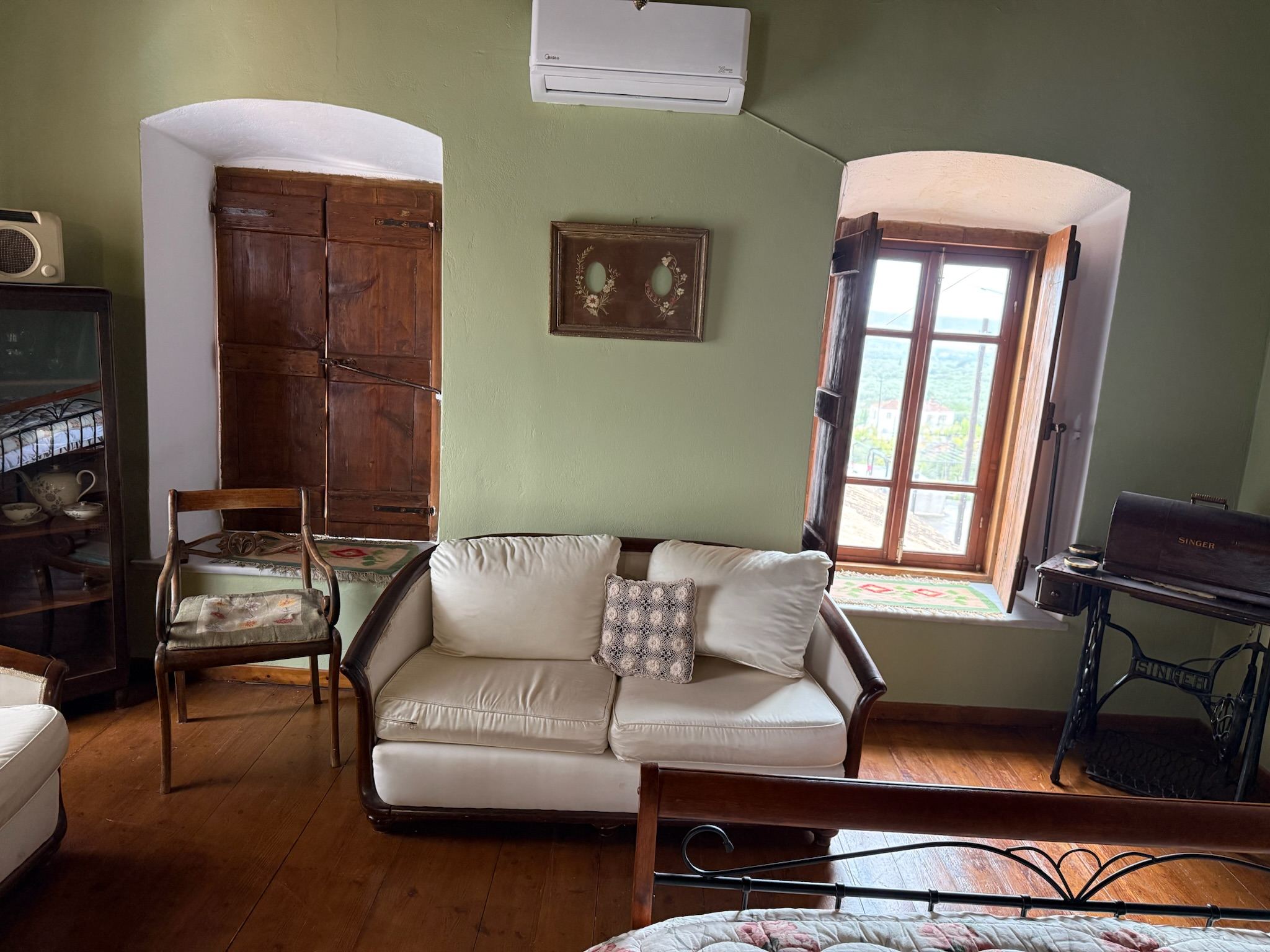 Vintage seating beside the traditional windows