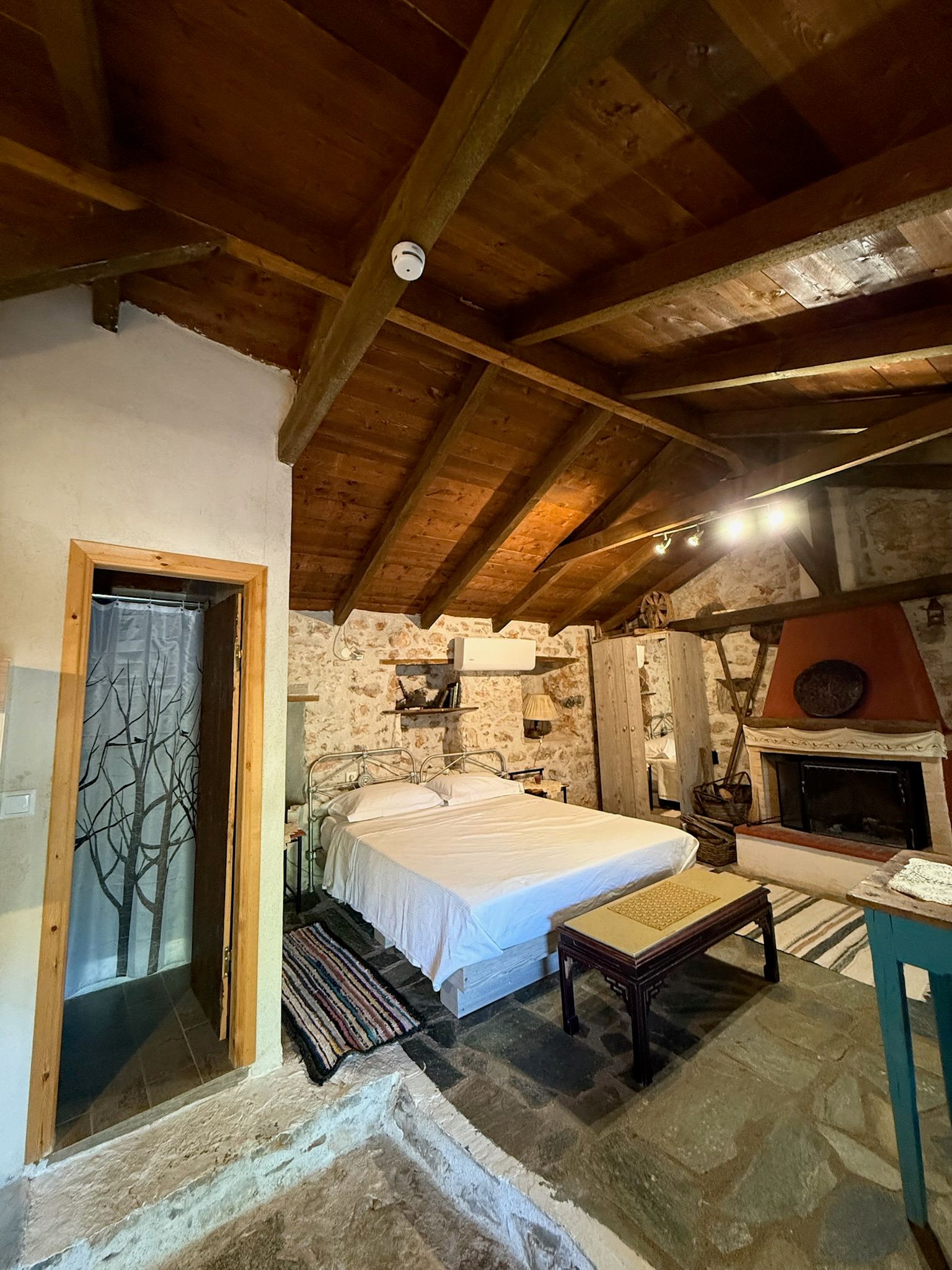 Sleeping area, fireplace and stone walls