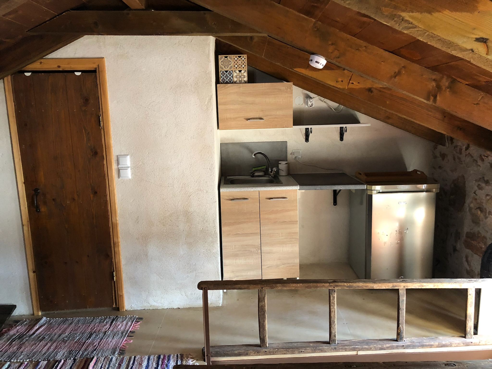 Refrigerator beneath the timber loft